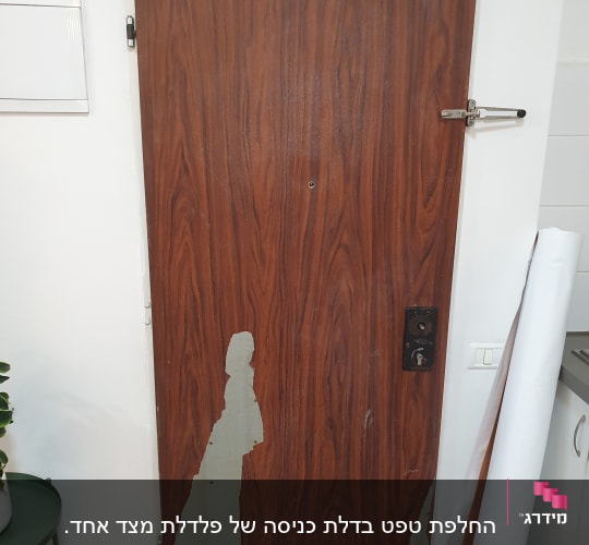דלת עץ עם ציפוי מתקלף בחלק התחתון